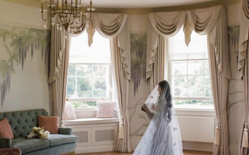 A bride posing in the Wisteria Room of Hylands House.